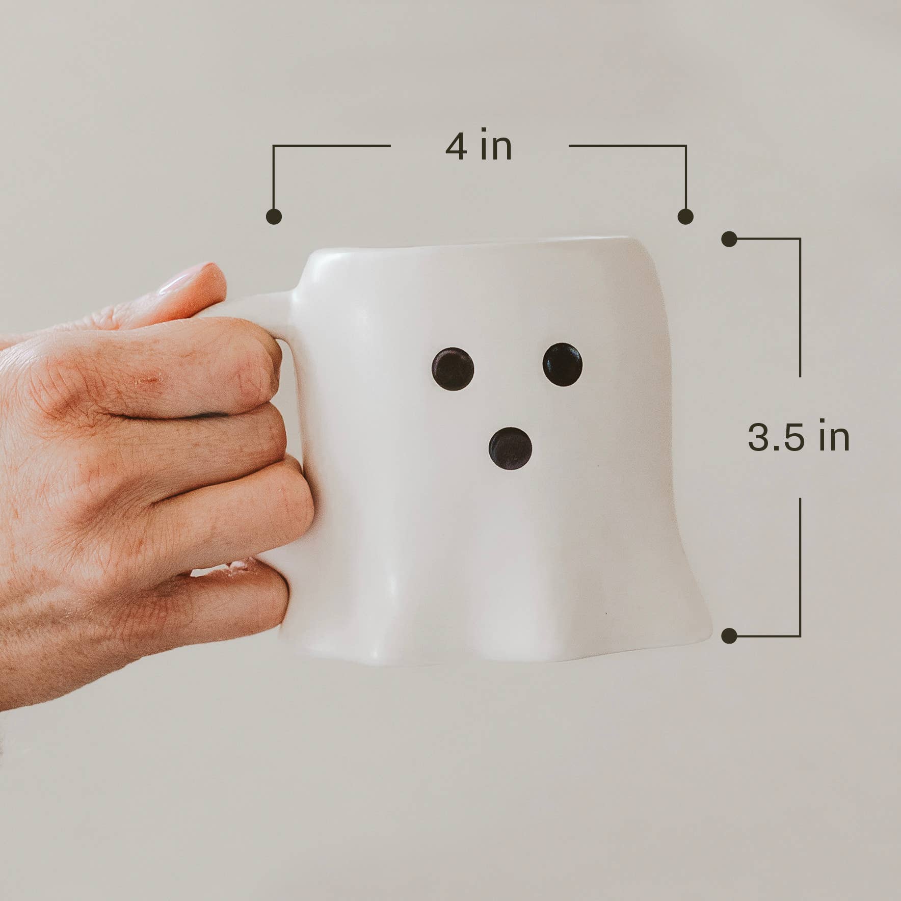 White mug with measurements on a light gray background