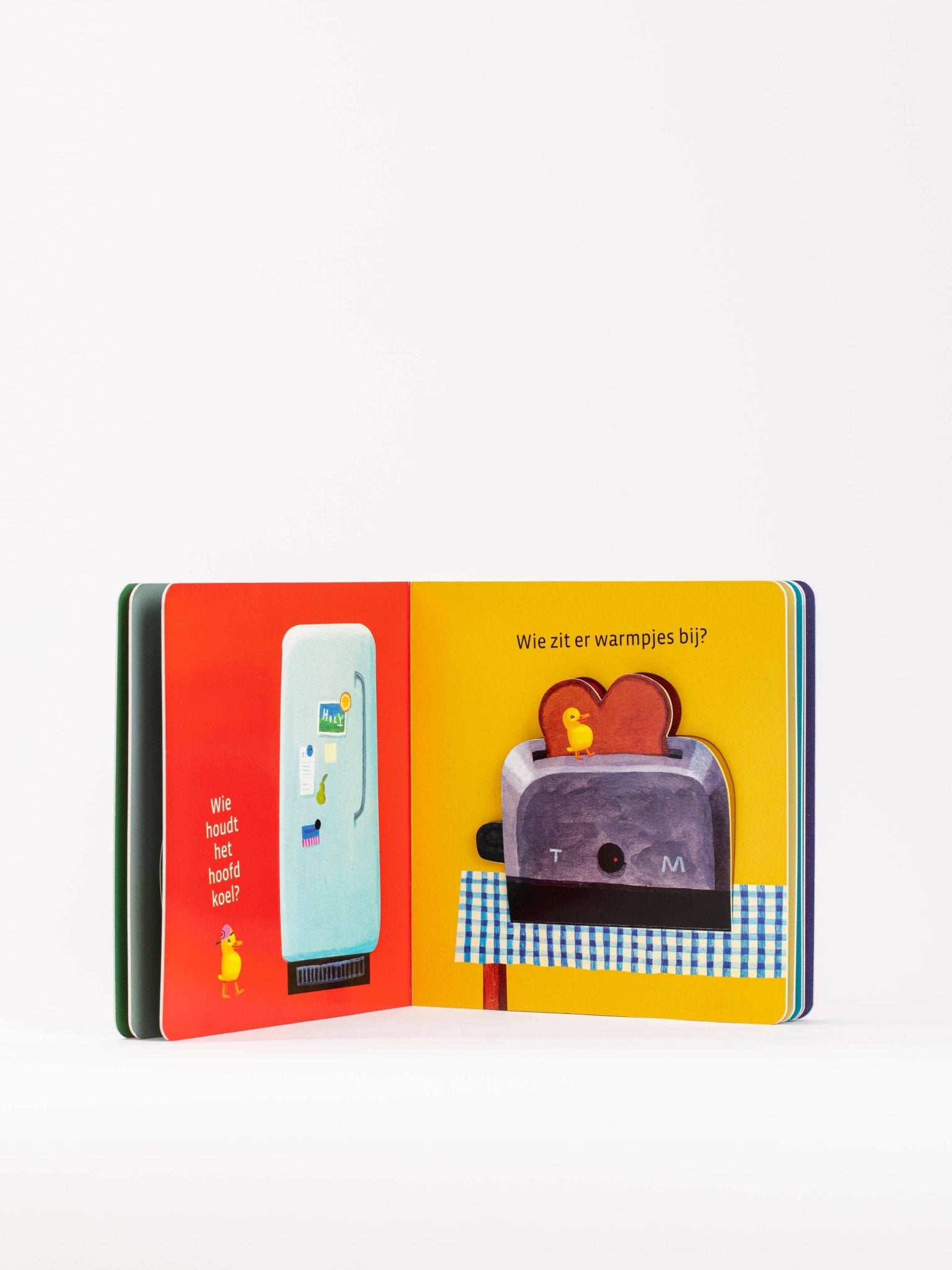 Open book with colorful illustration of a refrigerator and toaster on a white background