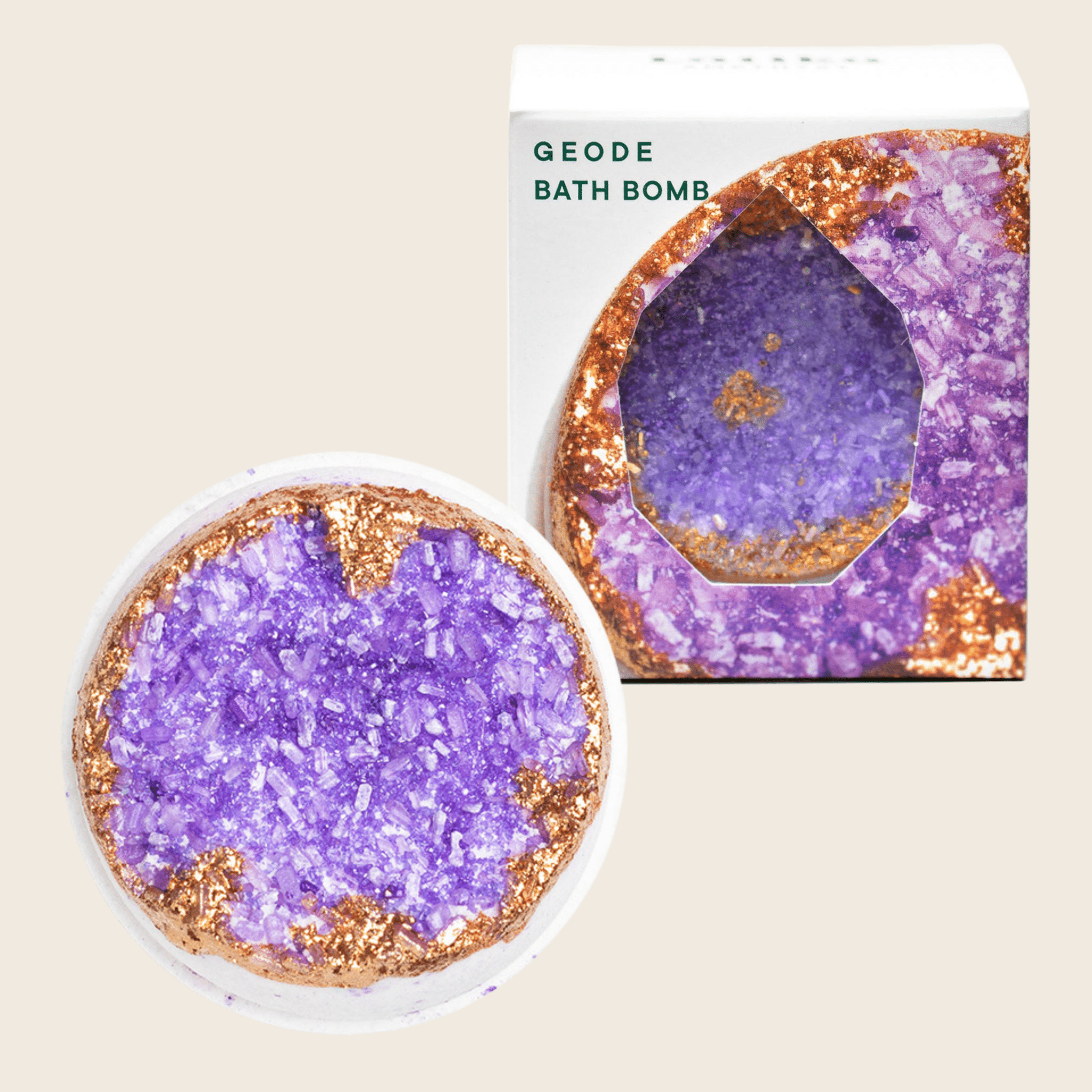 Geode bath bomb with gold glitter edges and purple crystal center, displayed with product box.