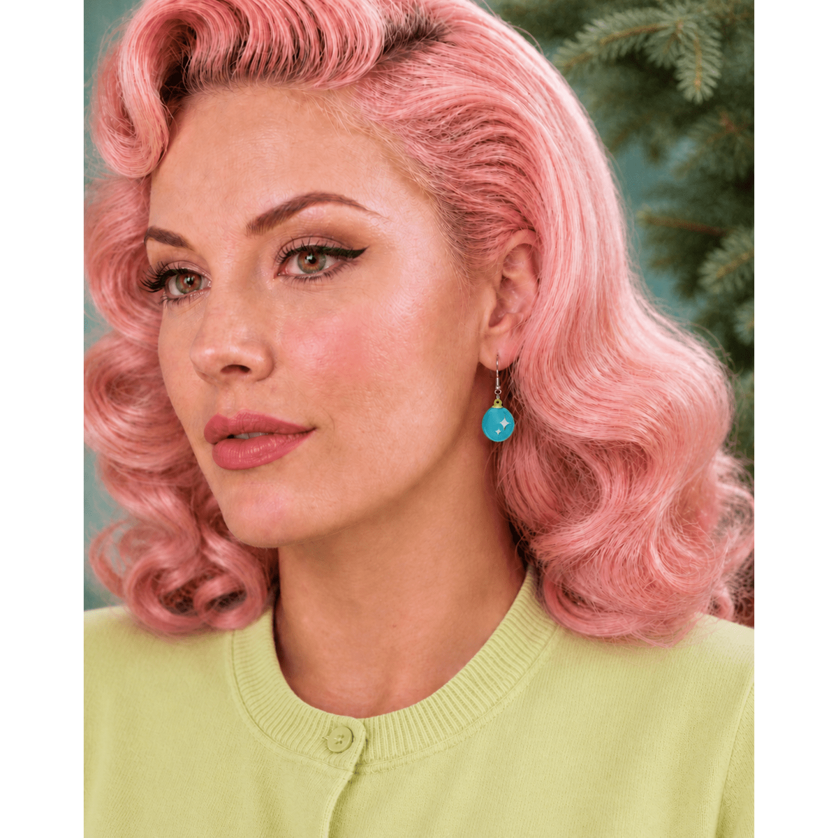 A close-up portrait of a woman with retro-style pink hair wearing a light yellow-green cardigan and a turquoise drop earring, set against a soft green background.