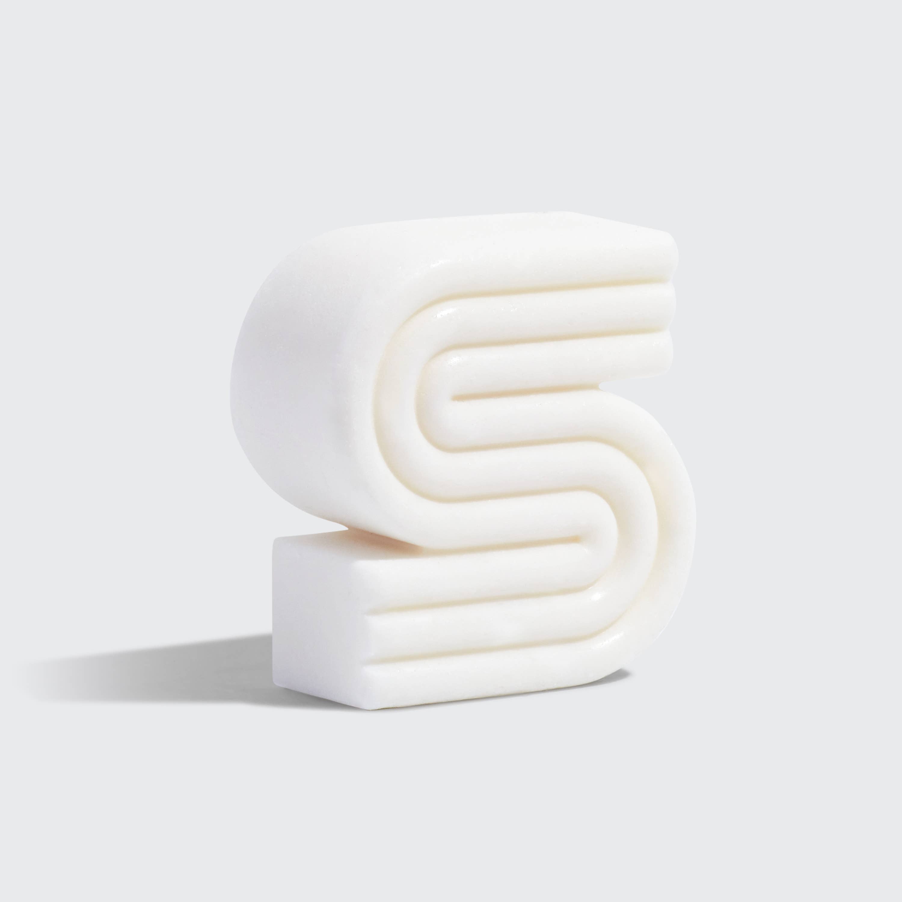 White S-shaped decorative candle with ribbed texture, ideal for modern home decor