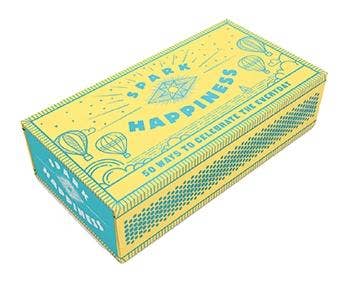 Spark Happiness card deck in a yellow and teal box. 50 ways to celebrate every day.
