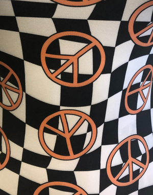 Black and white checker and orange peace signs fabric