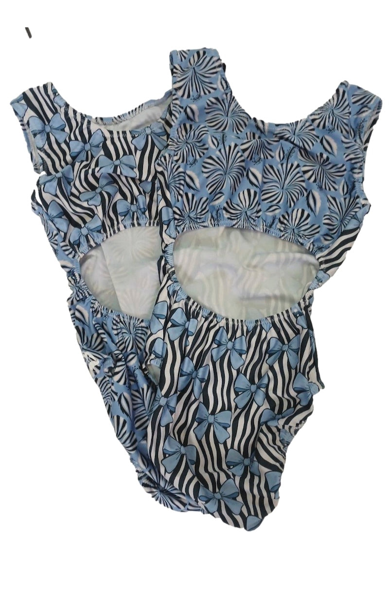 Two children's leotards with complimenting prints with floral and zebra pattern on a white background