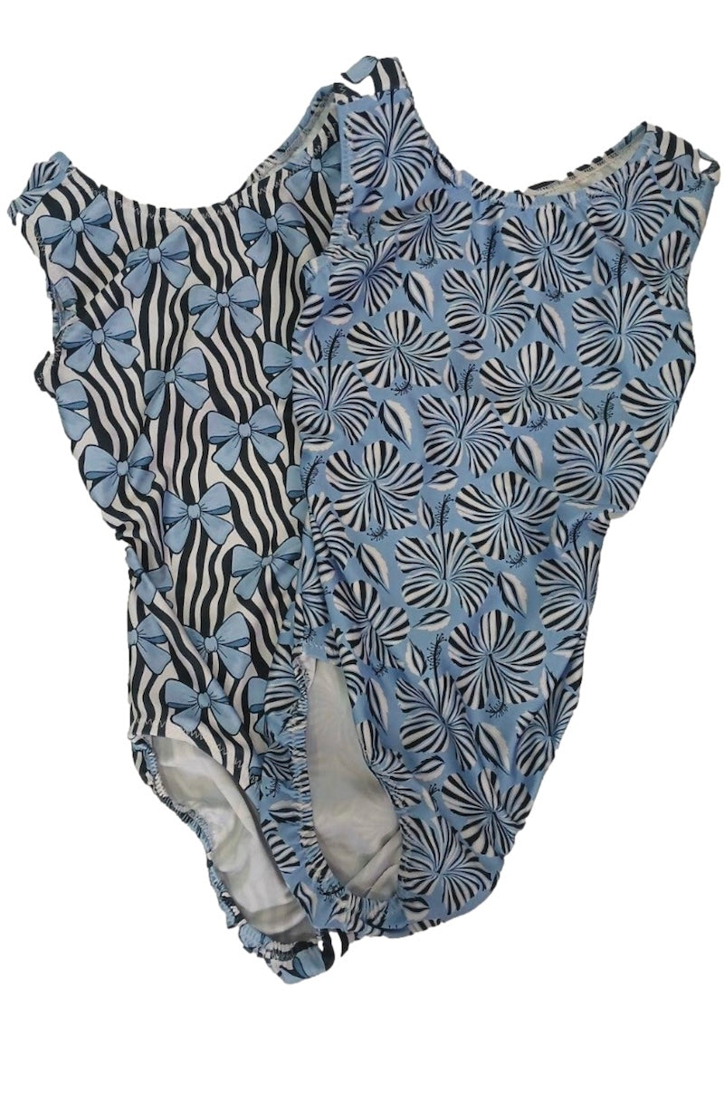 One-piece blue black and white leotards with bows and flowers zebra and floral pattern on a white background