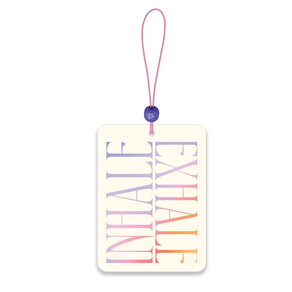 Inhale Exhale car air freshener with rainbow text and pink string.
