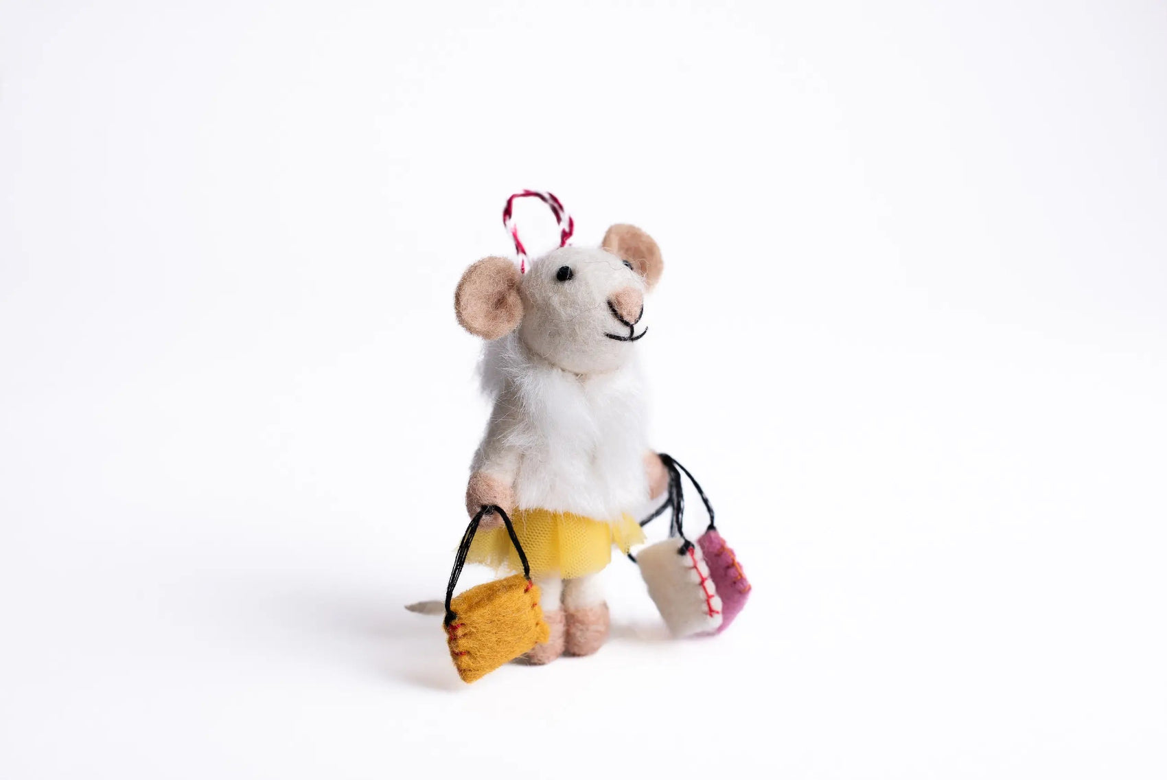 Stuffed mouse toy with shopping bags on a white background