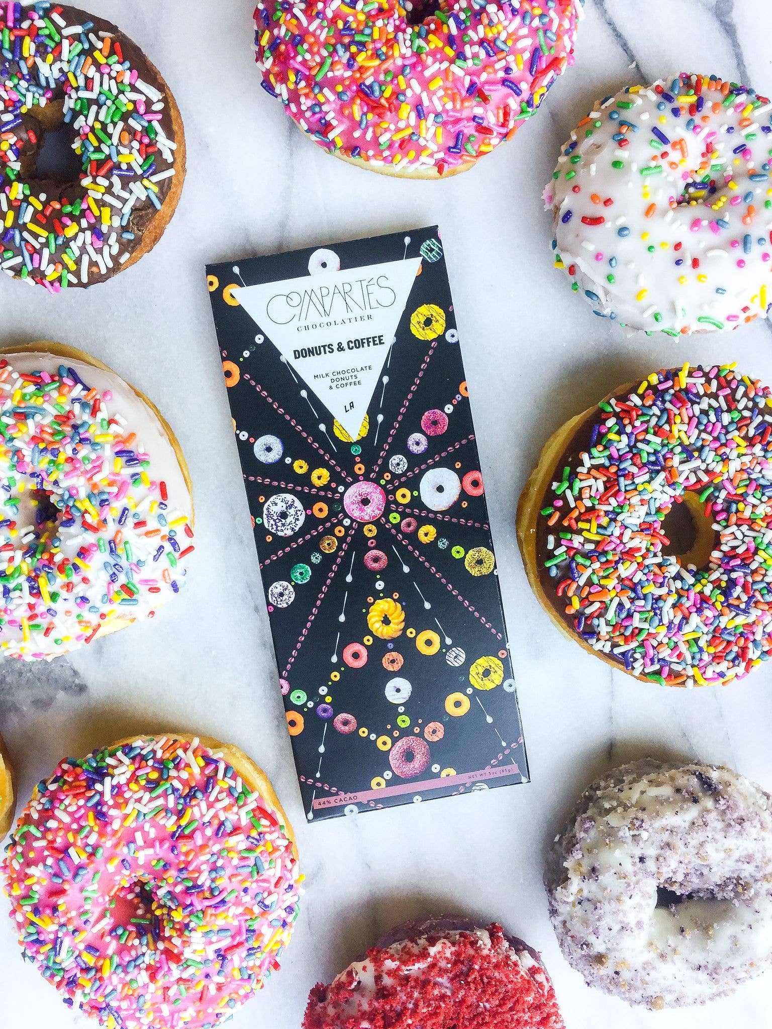 Colorful sprinkled donuts chocolate bar on a white surface
