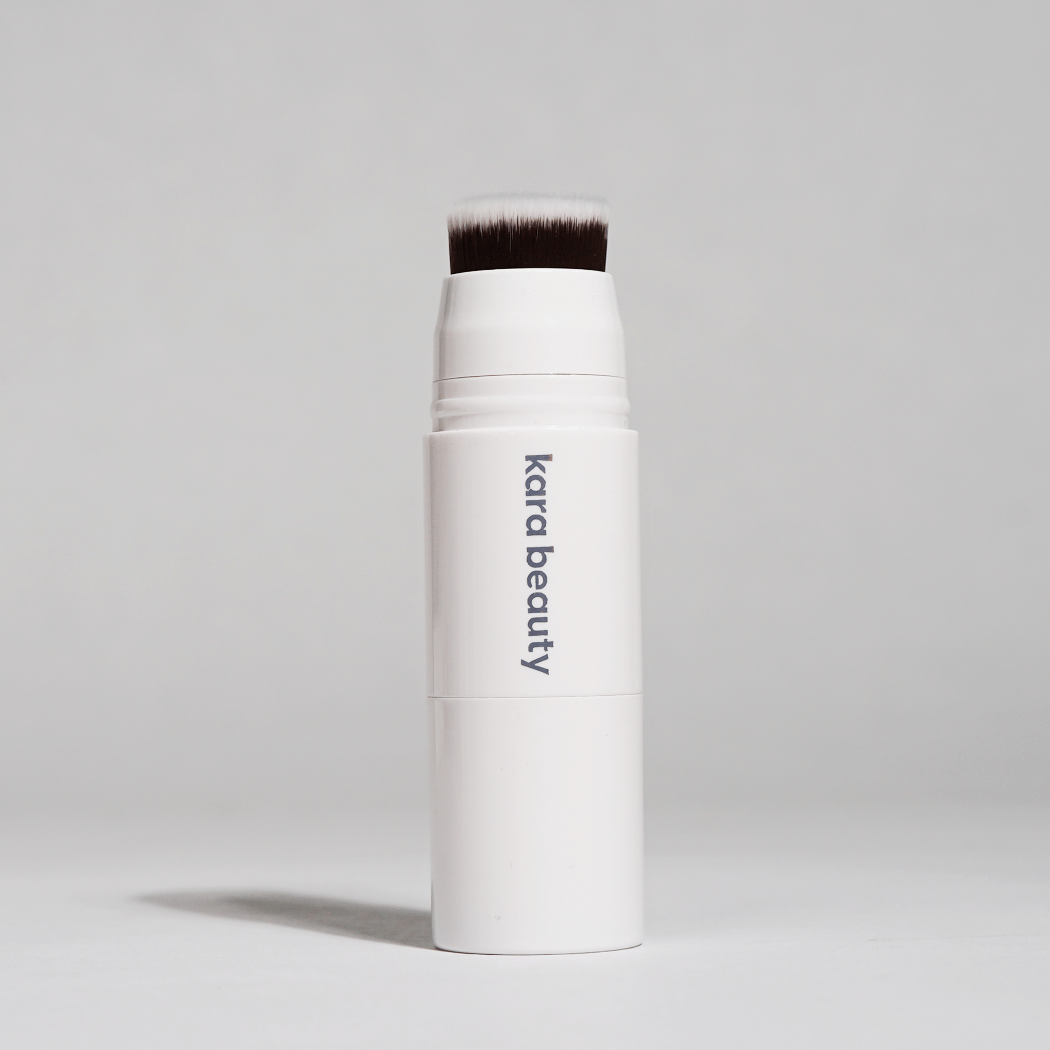 Kara Beauty contour stick with applicator brush.