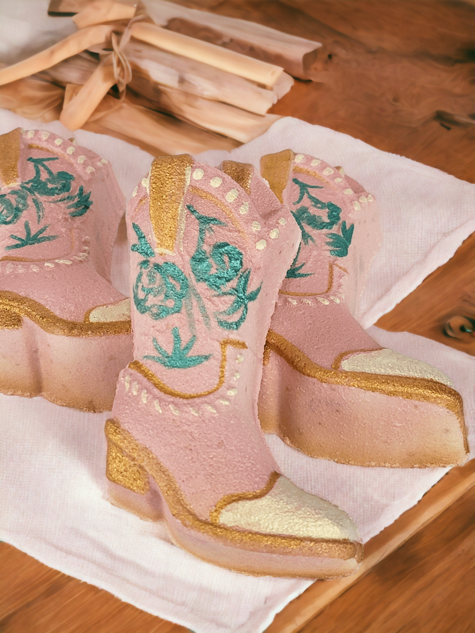 pink cowgirl boot bath bomb with teal flowers and gold trim