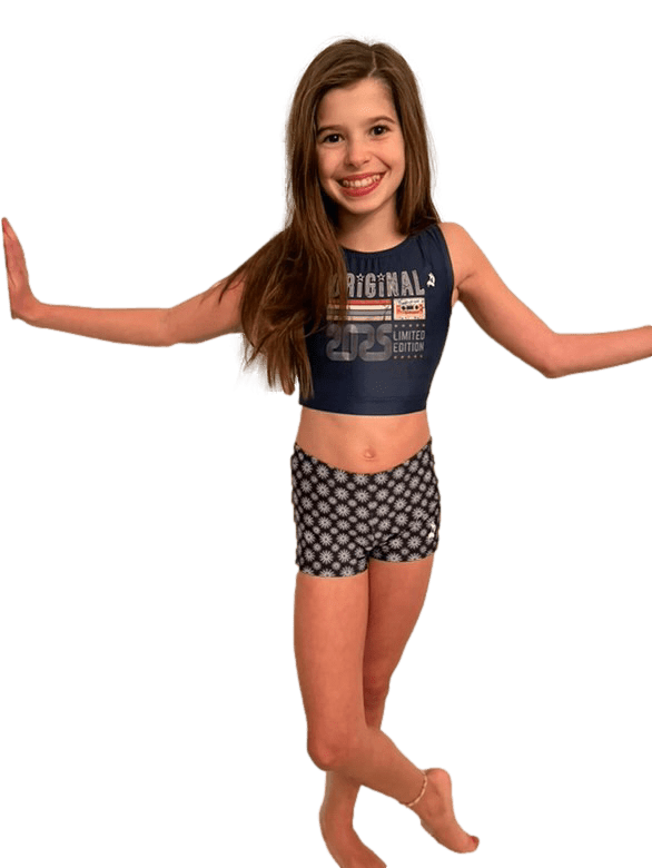 Girl in navy blue dance crop top and black/white patterned shorts.