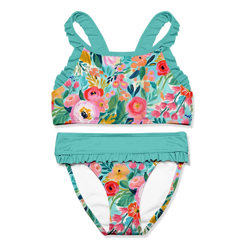 Girl's turquoise two-piece swimsuit with a floral print and ruffle details.