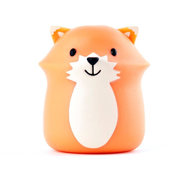 Orange fox-shaped toothbrush holder with white belly.