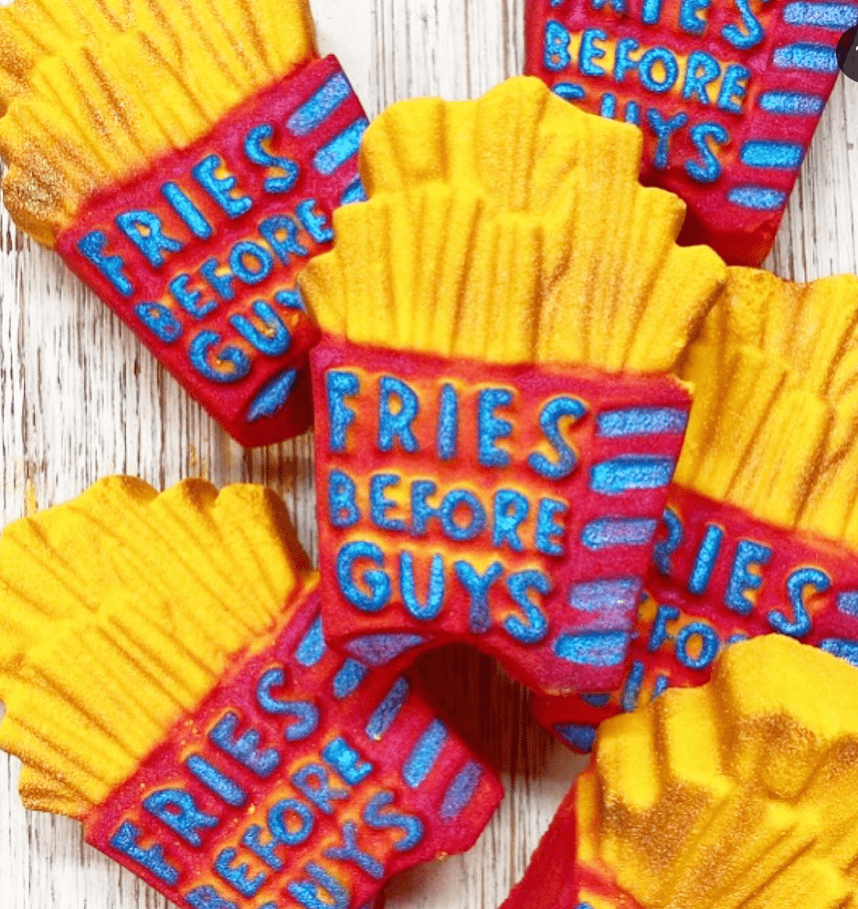 Fries Before Guys bath bomb shaped like french fries with a red container and blue lettering.