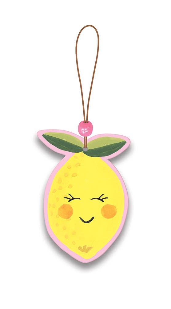 Hanging lemon-shaped car air freshener with a cute face and pink trim.