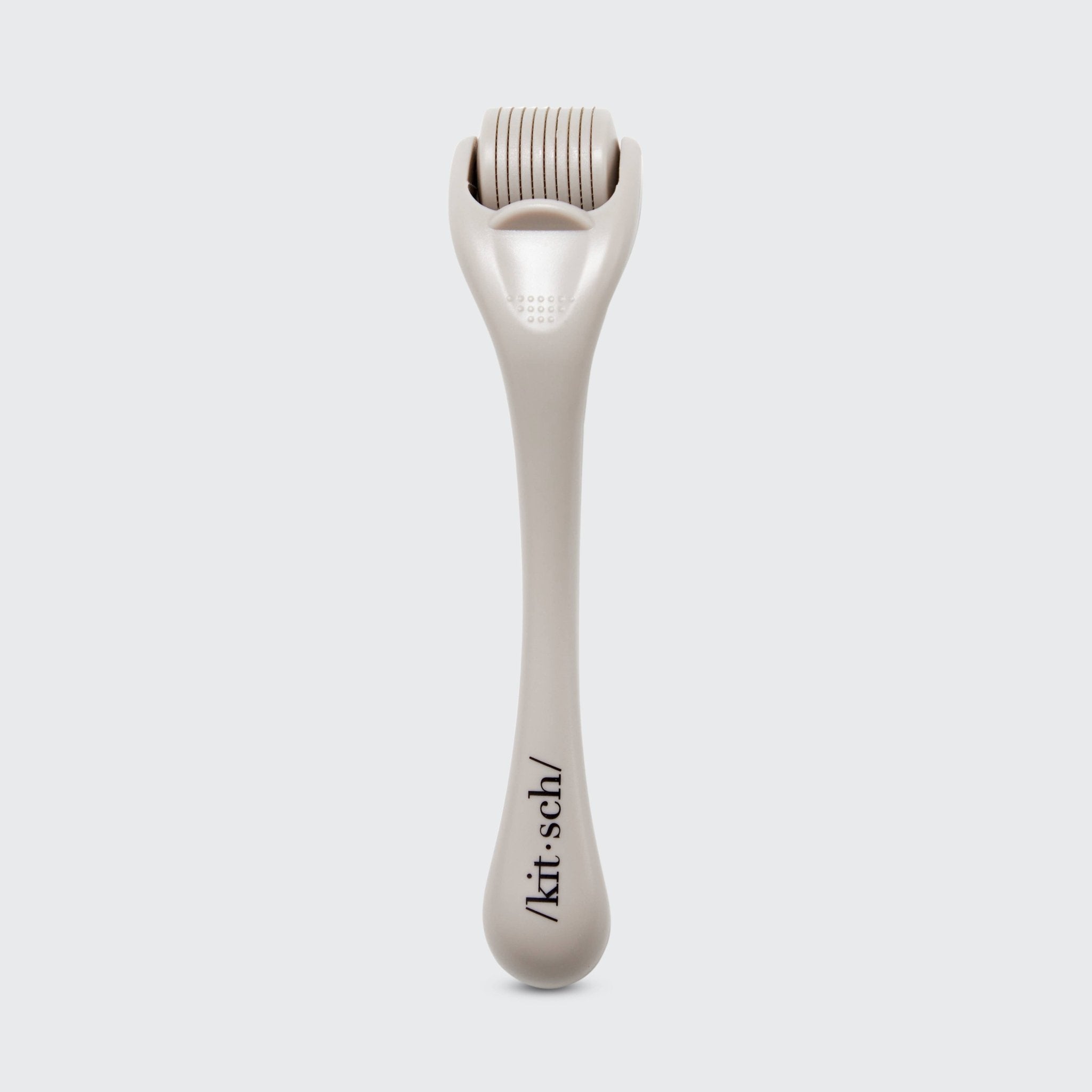 White derma roller with 'kit sch' branding on a light gray background