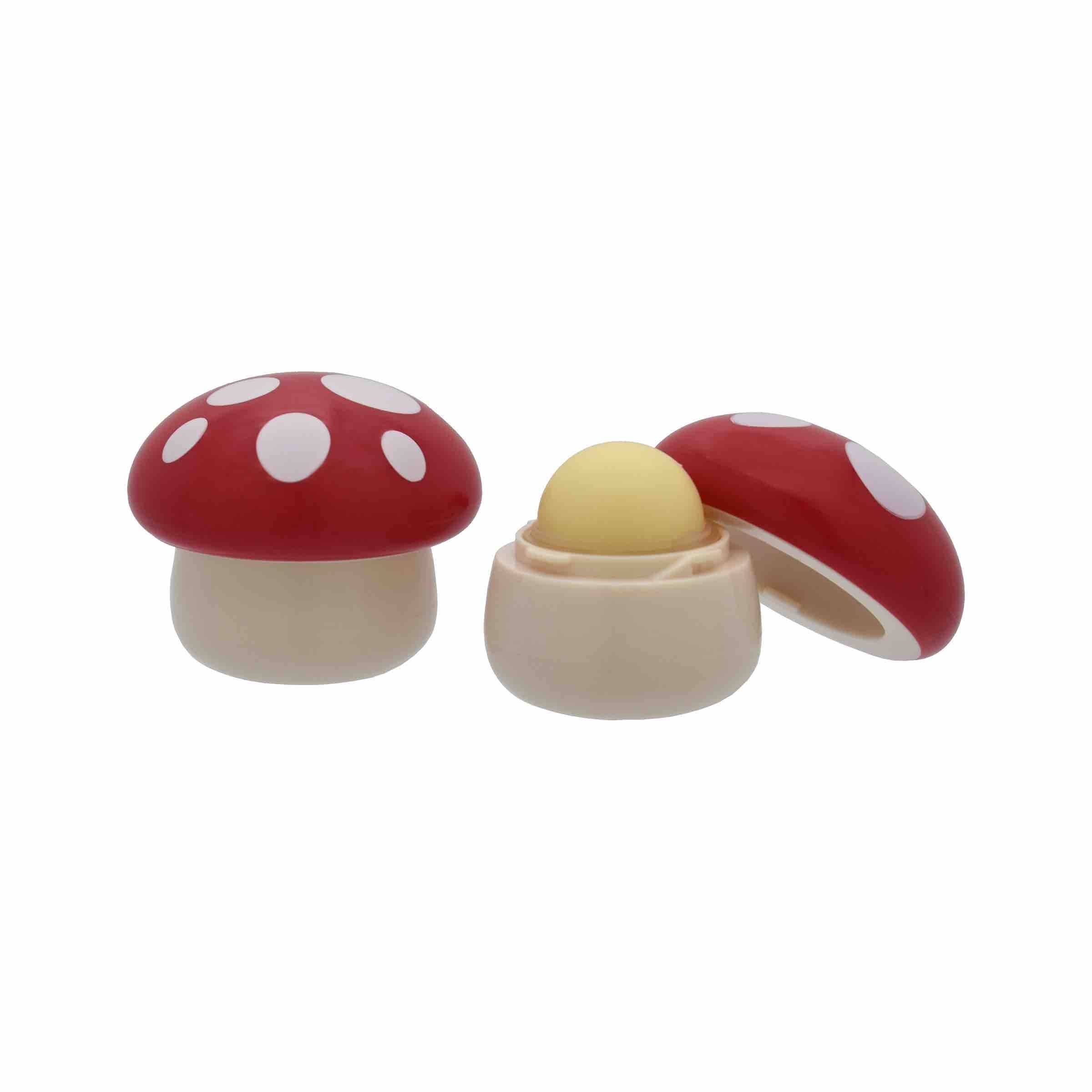 Mushroom-shaped vanilla lip balm with red and white dotted cap. Open to show the yellow balm.