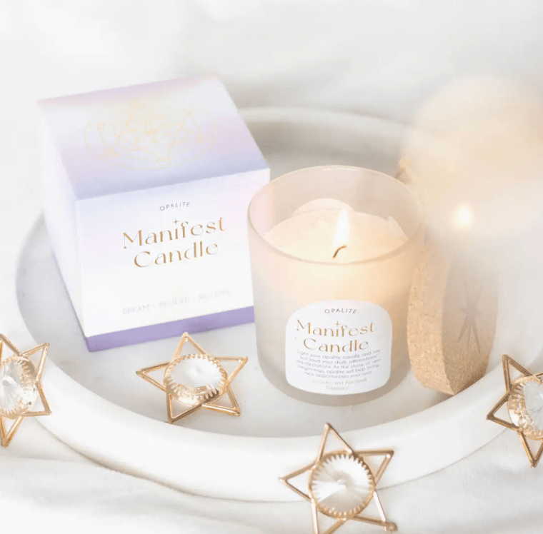 Opalite Manifest Candle with box, lavender patchouli scent, on white tray with star decor.