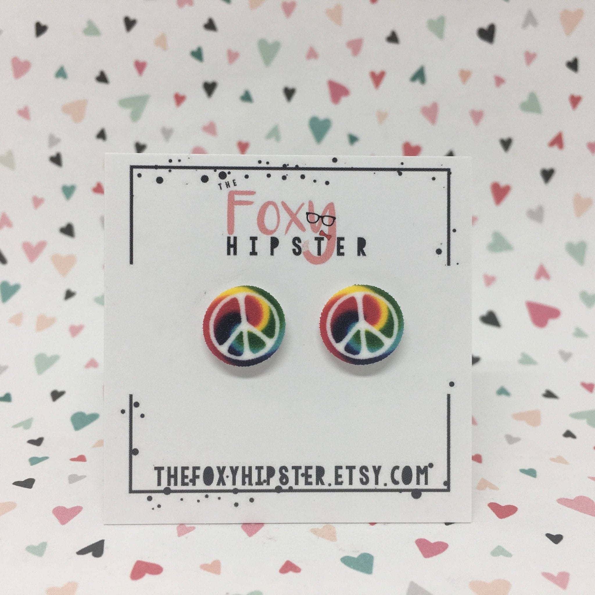 Tie dye peace sign stud earrings; rainbow peace earrings on card.