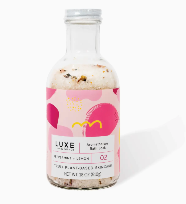 pappermint and lemon bath soak salts in a clear glass bottle