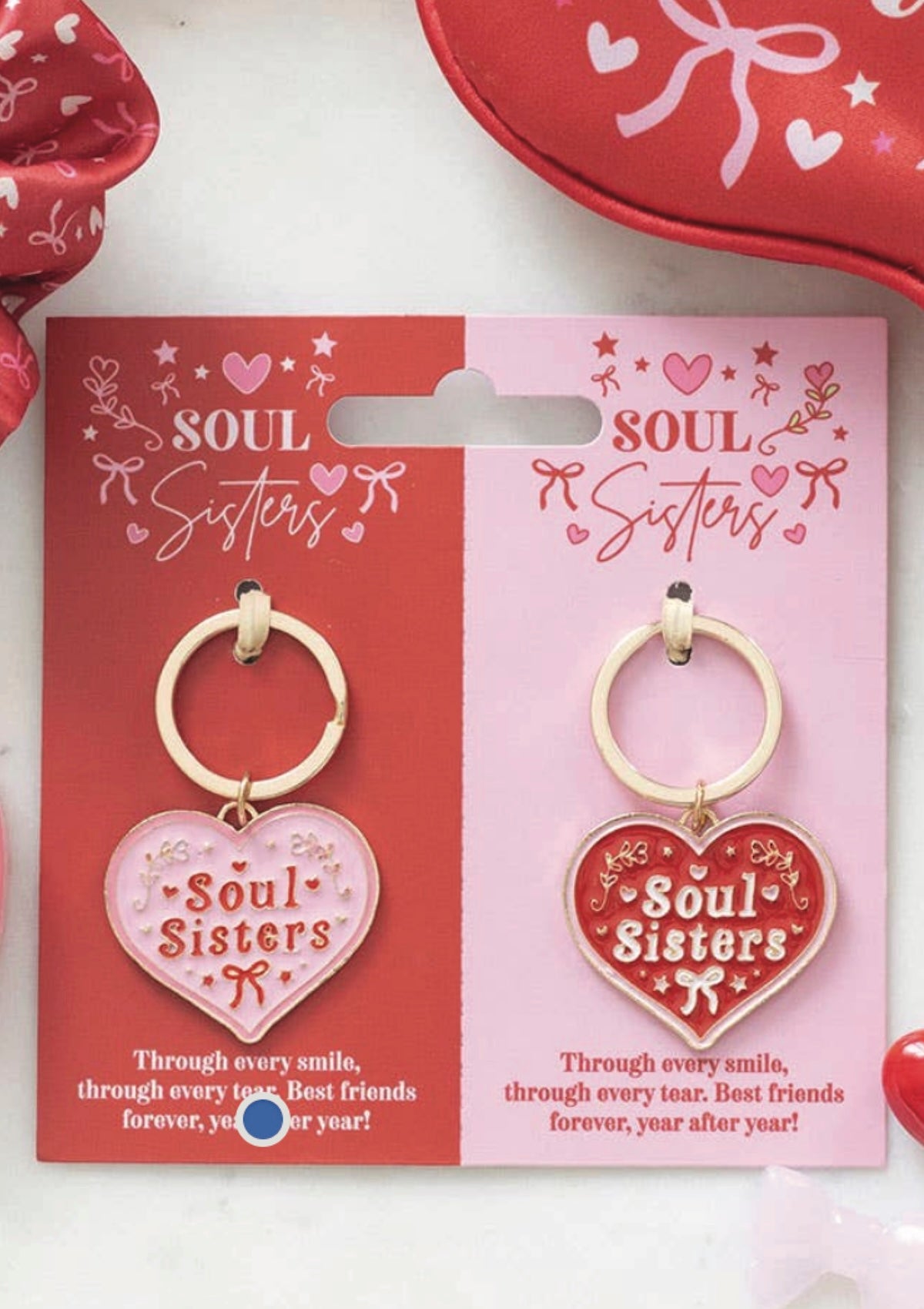 Heart-shaped 'Soul Sisters' keychains on packaging with red and pink design.