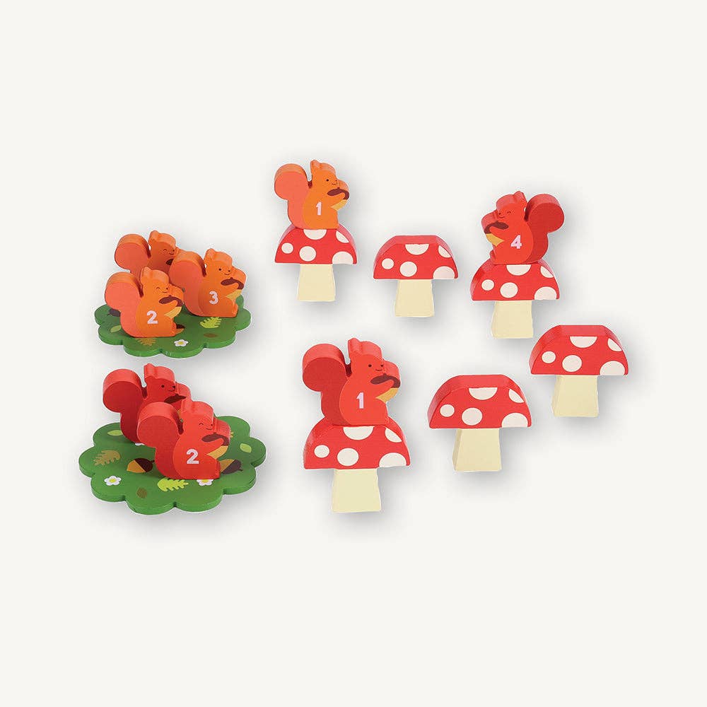 Set of wooden toys with red mushroom hats and various animal figures on a white background