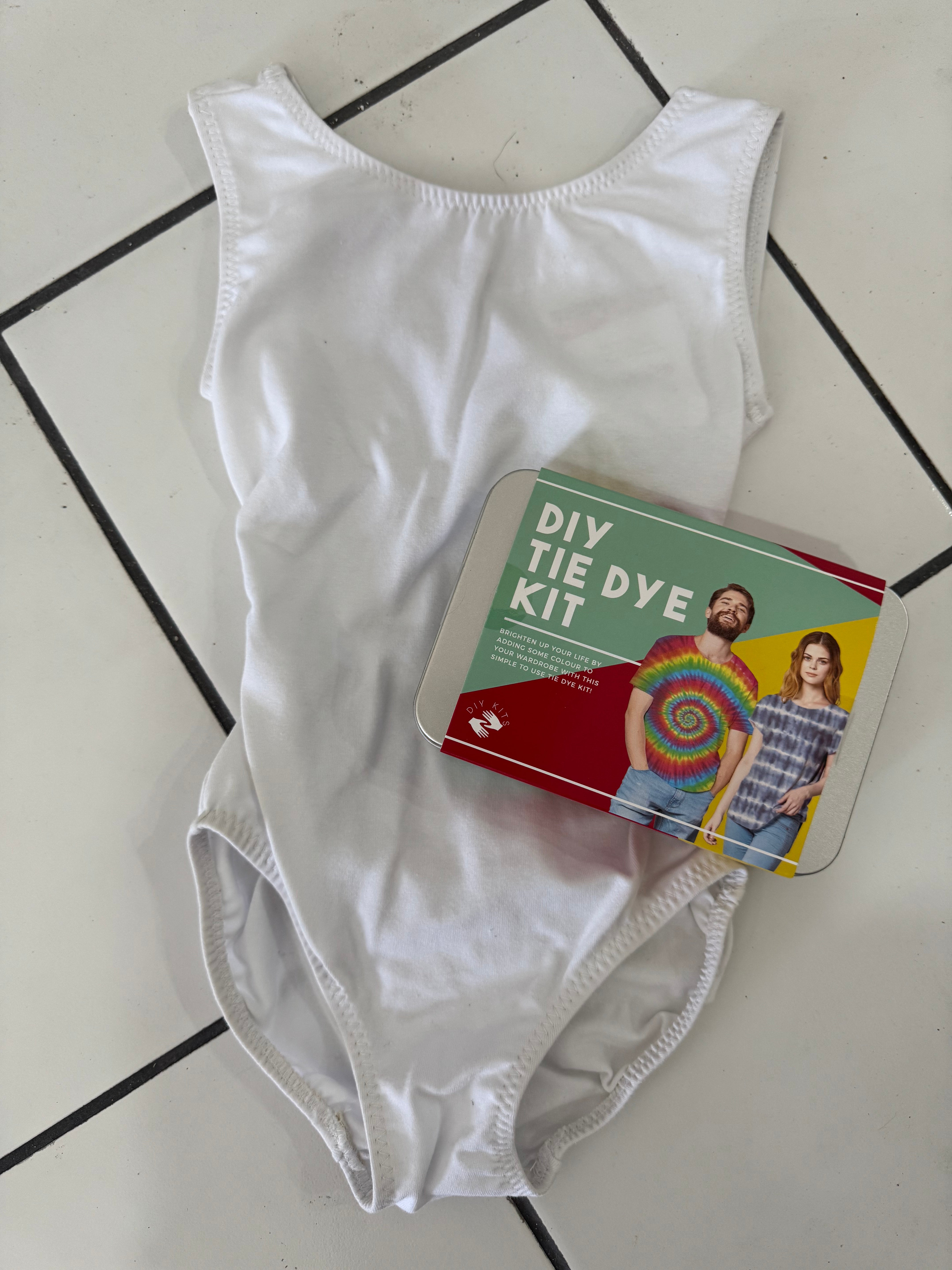 White cotton leotard with a DIY tie-dye kit for customizing the garment.