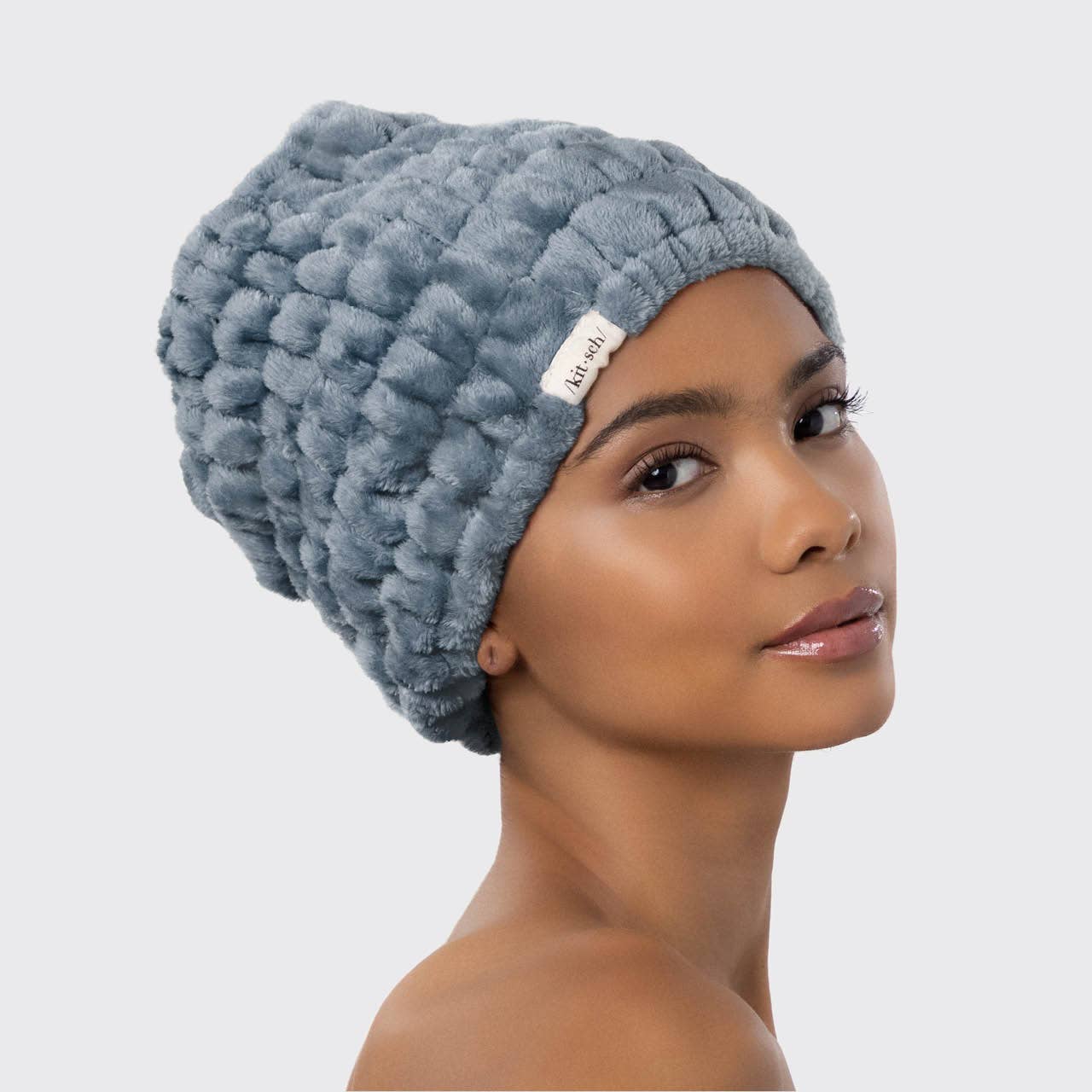 Woman wearing a Kitsch Microfiber Hair Towel Wrap in gray.
