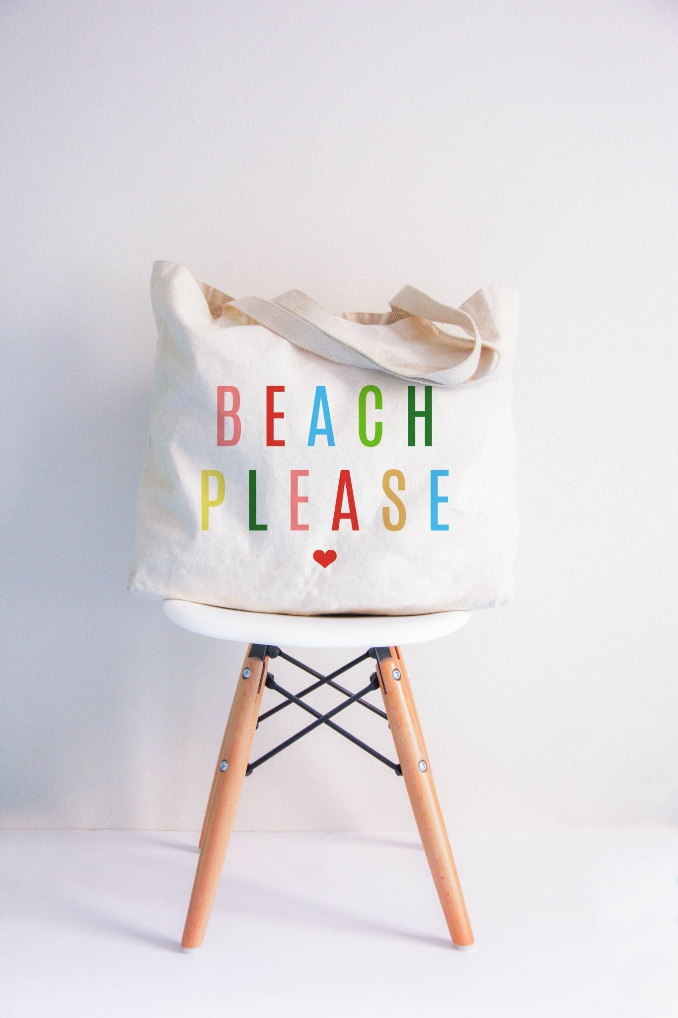 Canvas tote bag with 'BEACH PLEASE' text in colorful letters and a heart, suitable for beach trips.