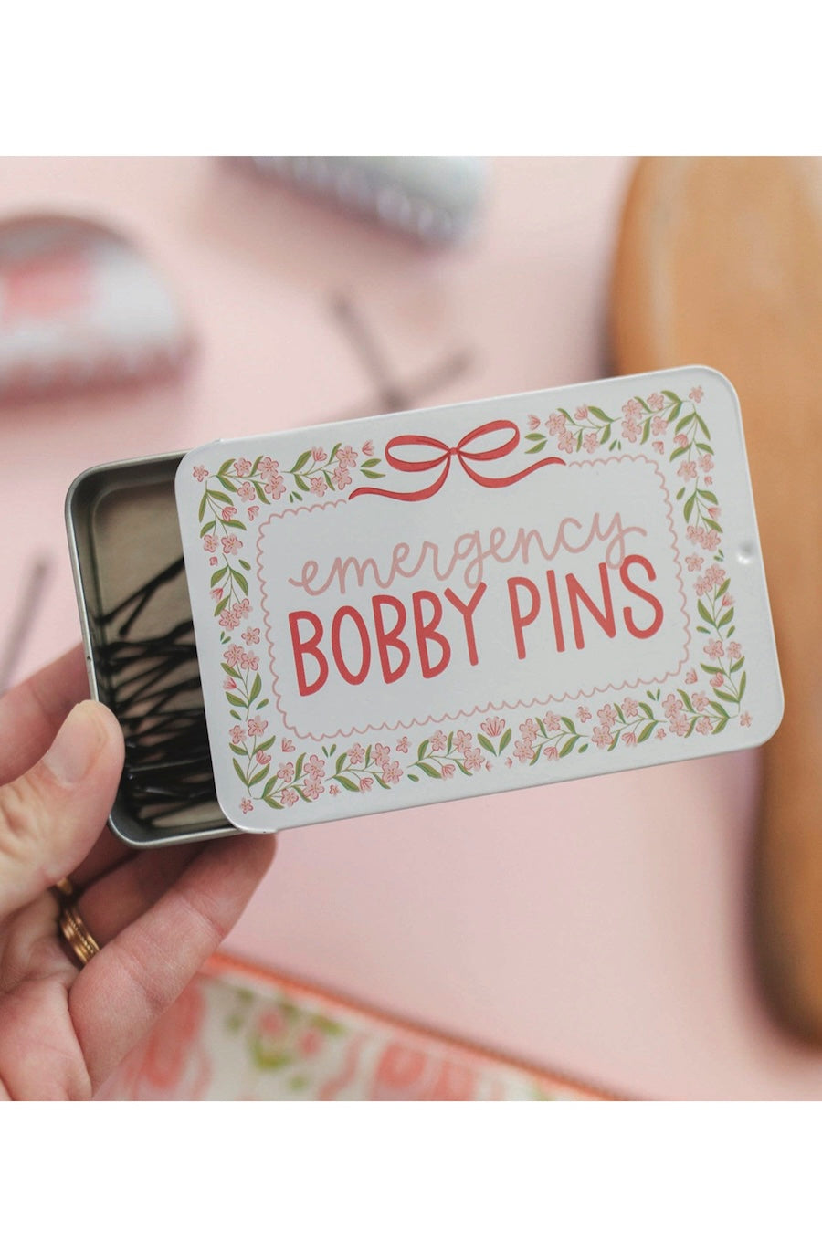tin that says emergency bobby pins