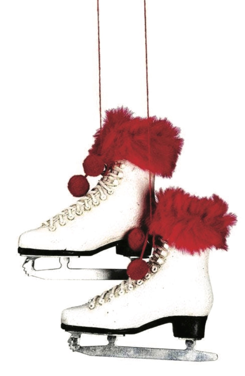 Decorative ice skate with red feathers and pom-poms on a white background