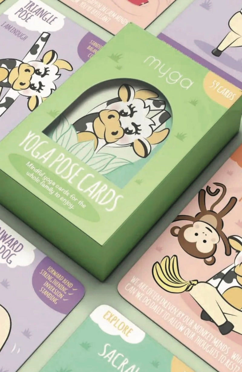 Box of yoga pose cards with cartoon illustrations on a colorful background