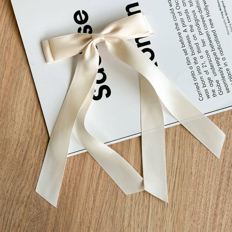 Off-white double hair bow with long ribbon tails.