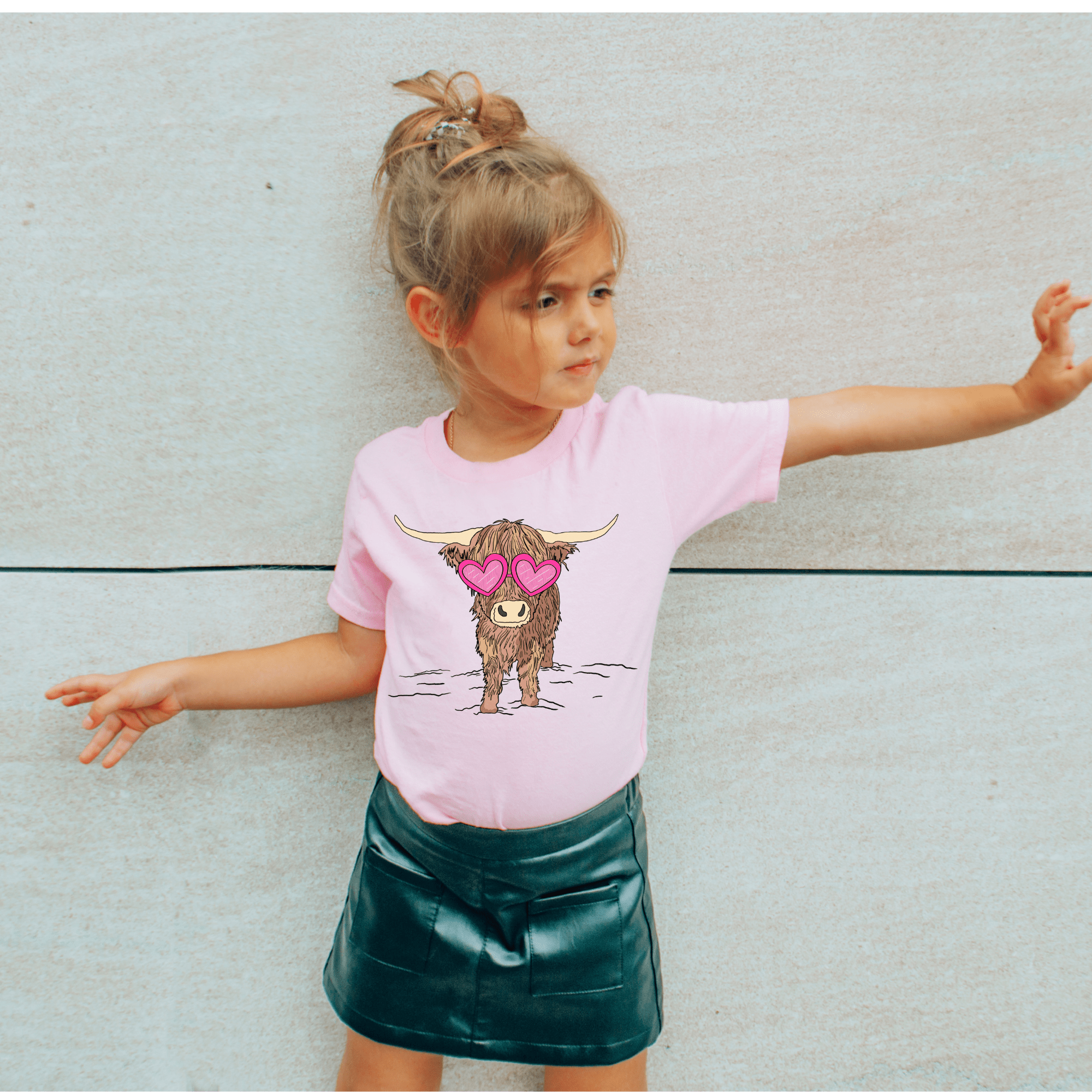 Girl's pink t-shirt with a cow wearing heart sunglasses graphic.
