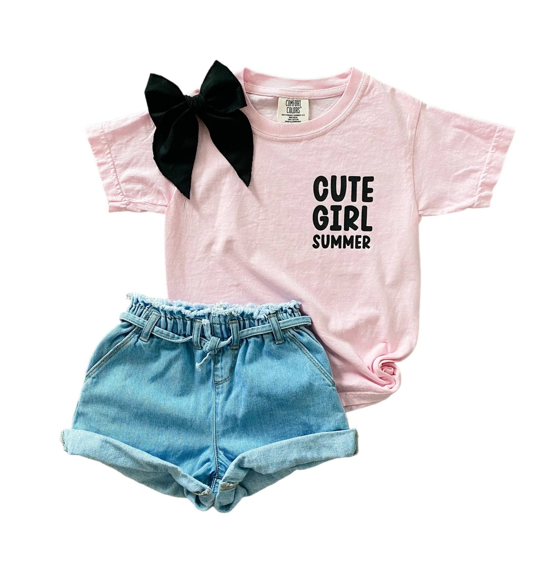 Girl's pink 'Cute Girl Summer' tee with black bow, denim paper bag shorts outfit.