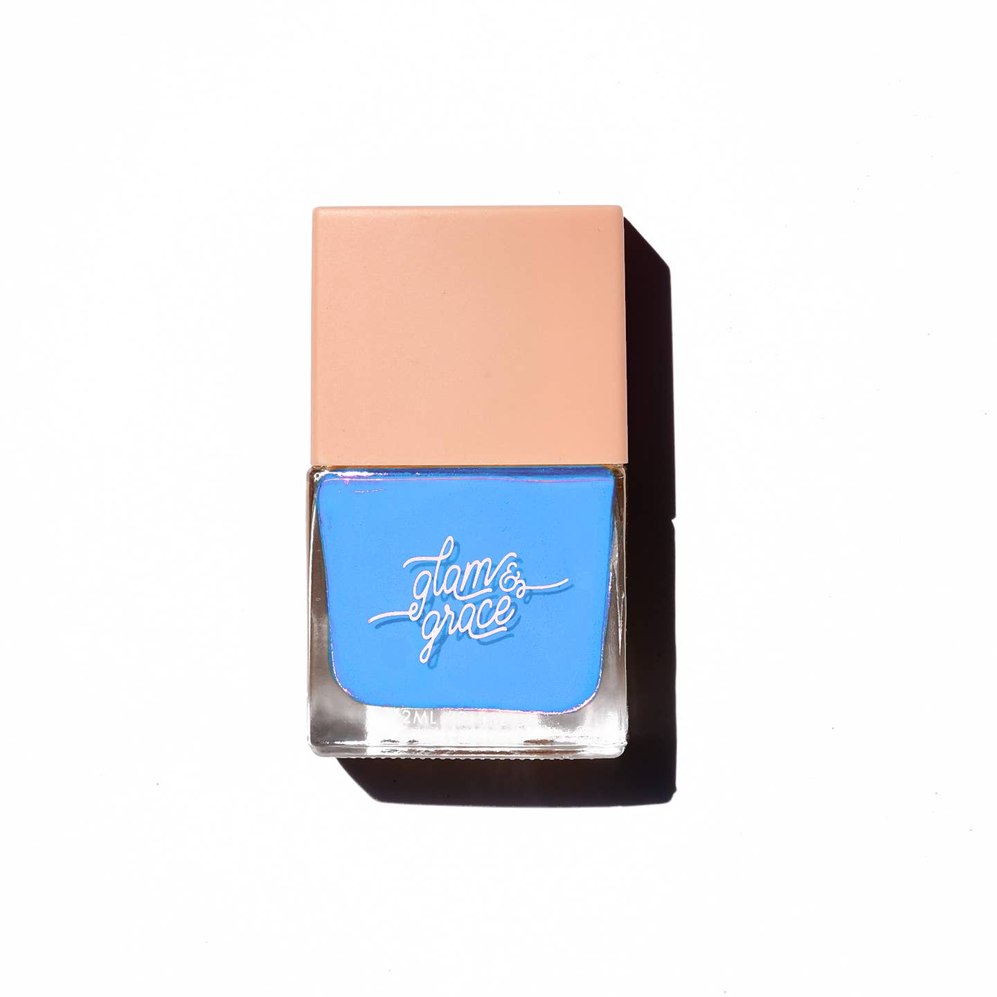 Glow & Glam non-toxic blue nail-polish in a clear glass bottle with beige-colored lid