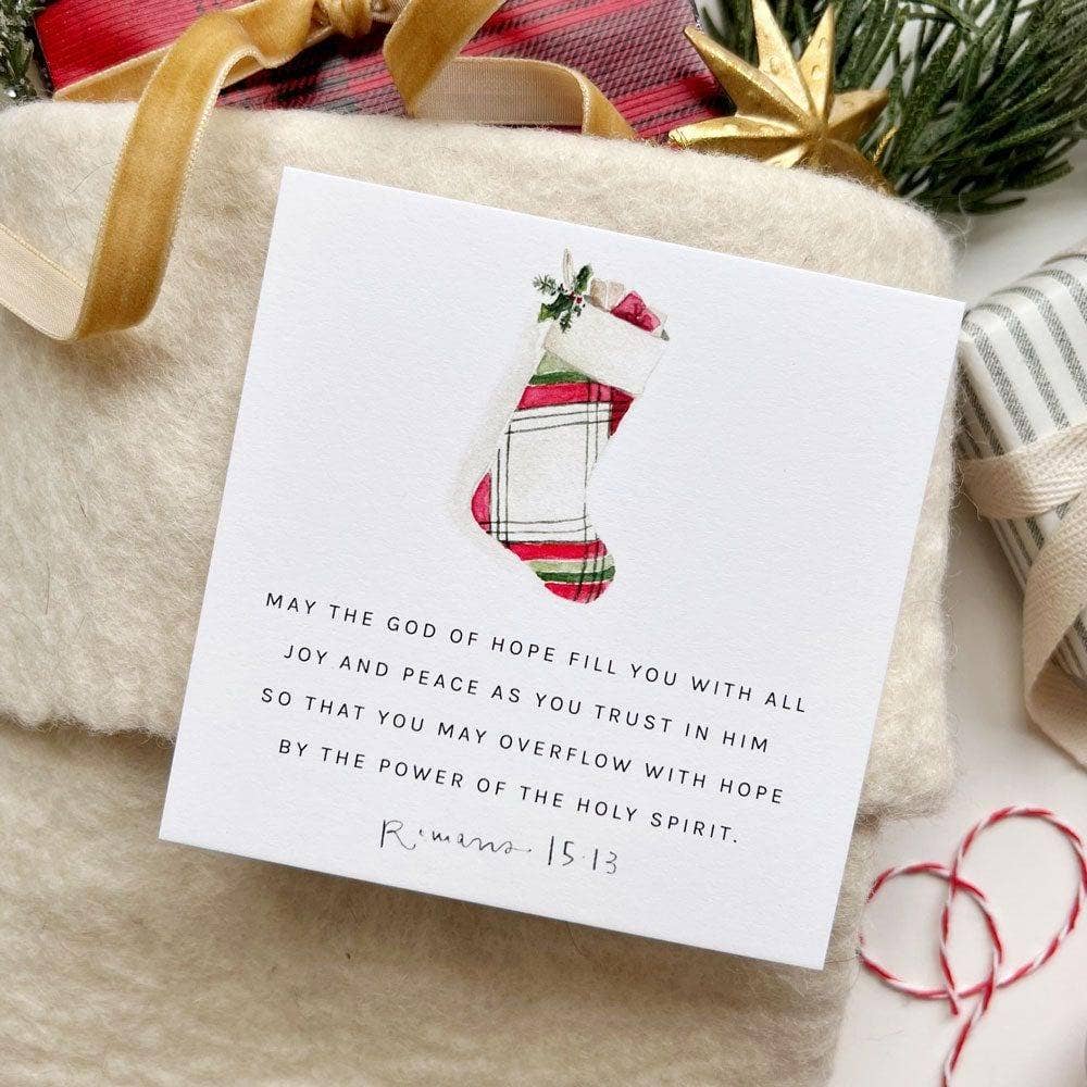 Christmas card with plaid stocking design and text on a gift-wrapped present.