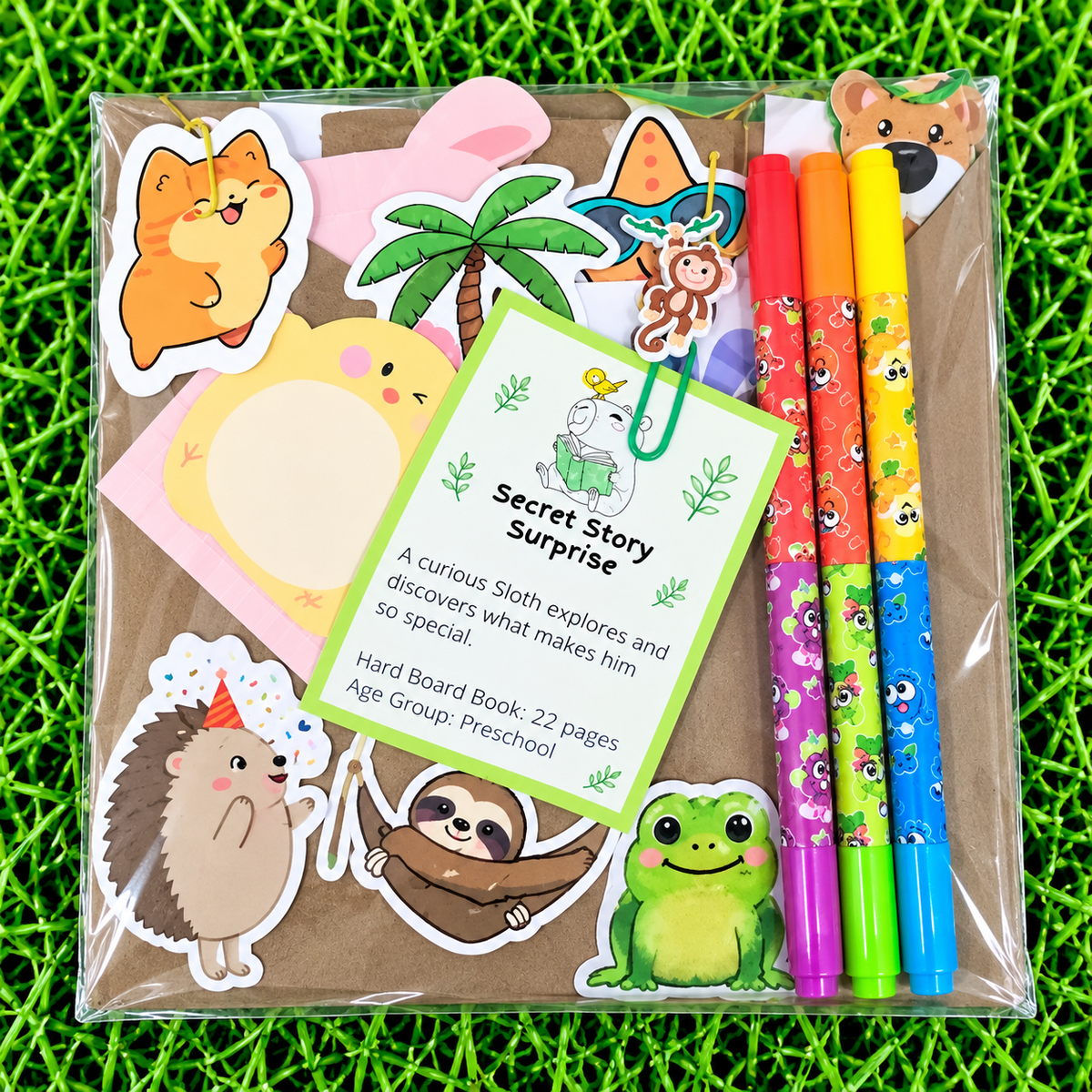 A packaged children's activity set labeled 'Secret Story Surprise' containing cartoon animal stickers, a notepad, a hard board book, and three colorful pens, placed on a bright green grass-like surface.