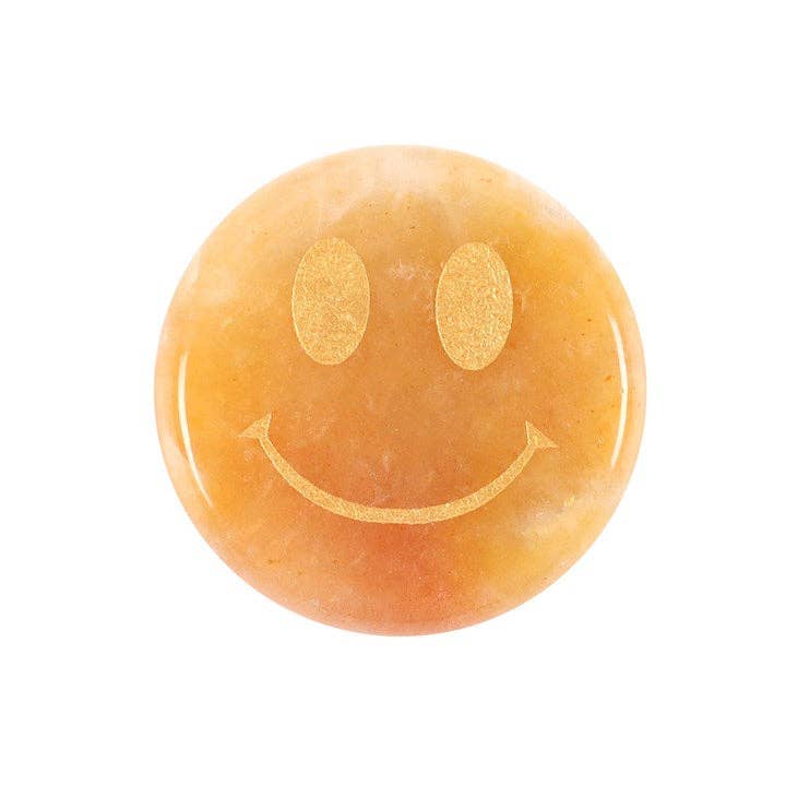 Orange aventurine crystal carved into a smiley face.
