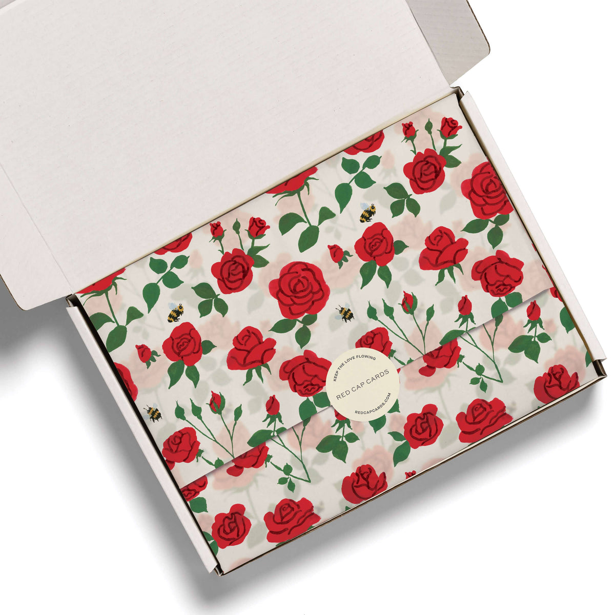 Cardboard box with red rose pattern on a white background