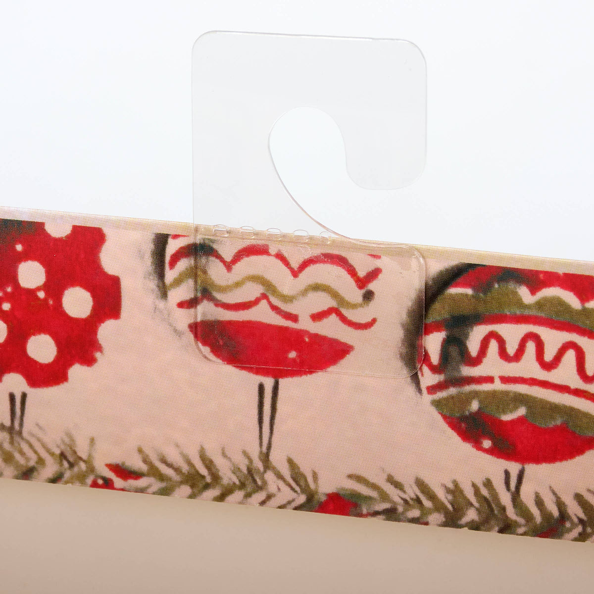 Close-up of a decorative ribbon with red floral patterns on a white background