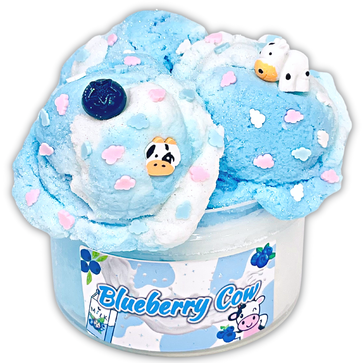 A blue and white slime product in a clear plastic tub with a 'Blueberry Cow' label, topped with decorative cow and cloud shapes and blueberry accents.