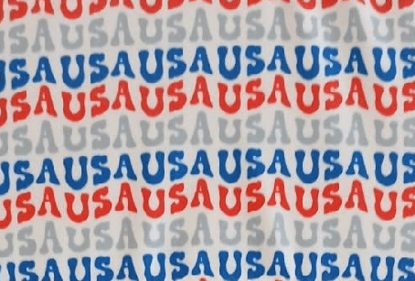 Text pattern with 'USA' in red, blue, and gray on a fabric background