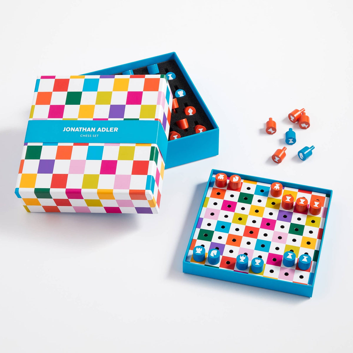 Colorful board game with checkered box and Jonathan Adler branding on a white background