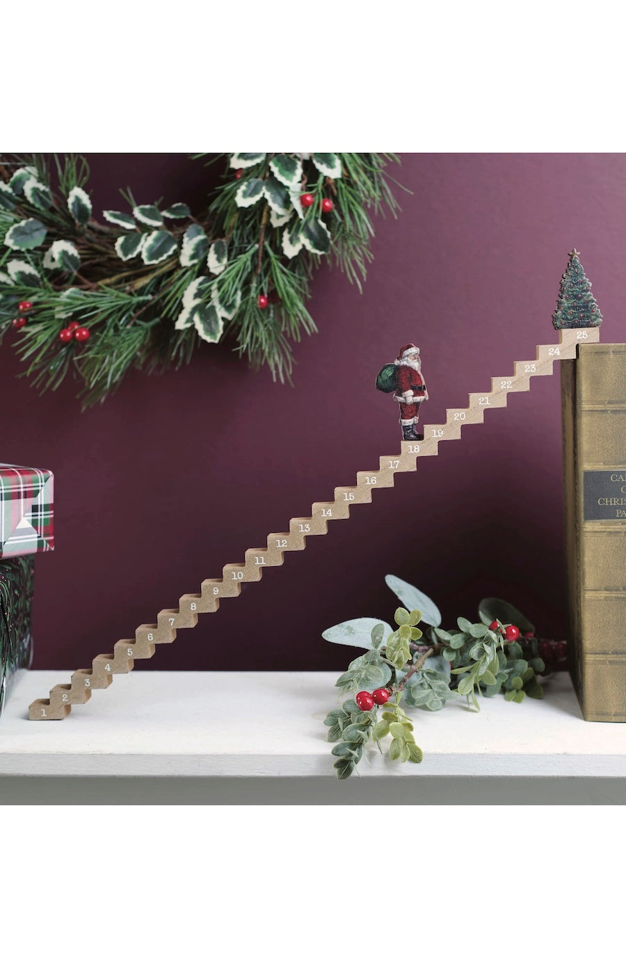 Christmas Advent Calender thats steps with a santa leading up to a Christmas tree