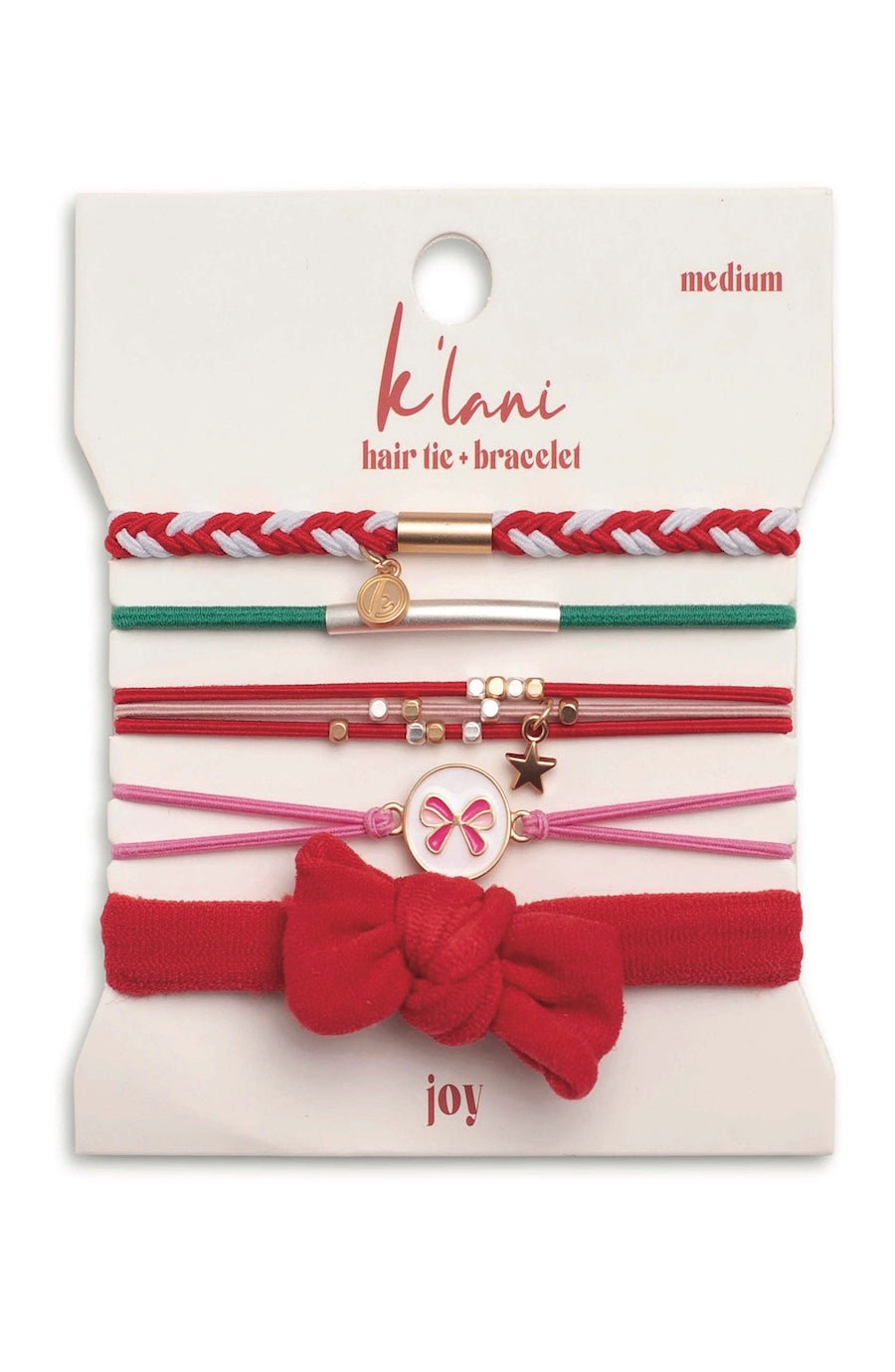 A set of K'lnni 'joy' medium hair tie and bracelet set on a white backing card. The set includes red and white braided, green and red, red and white with gold beads, pink and white with gold beads, and a red bow headband.