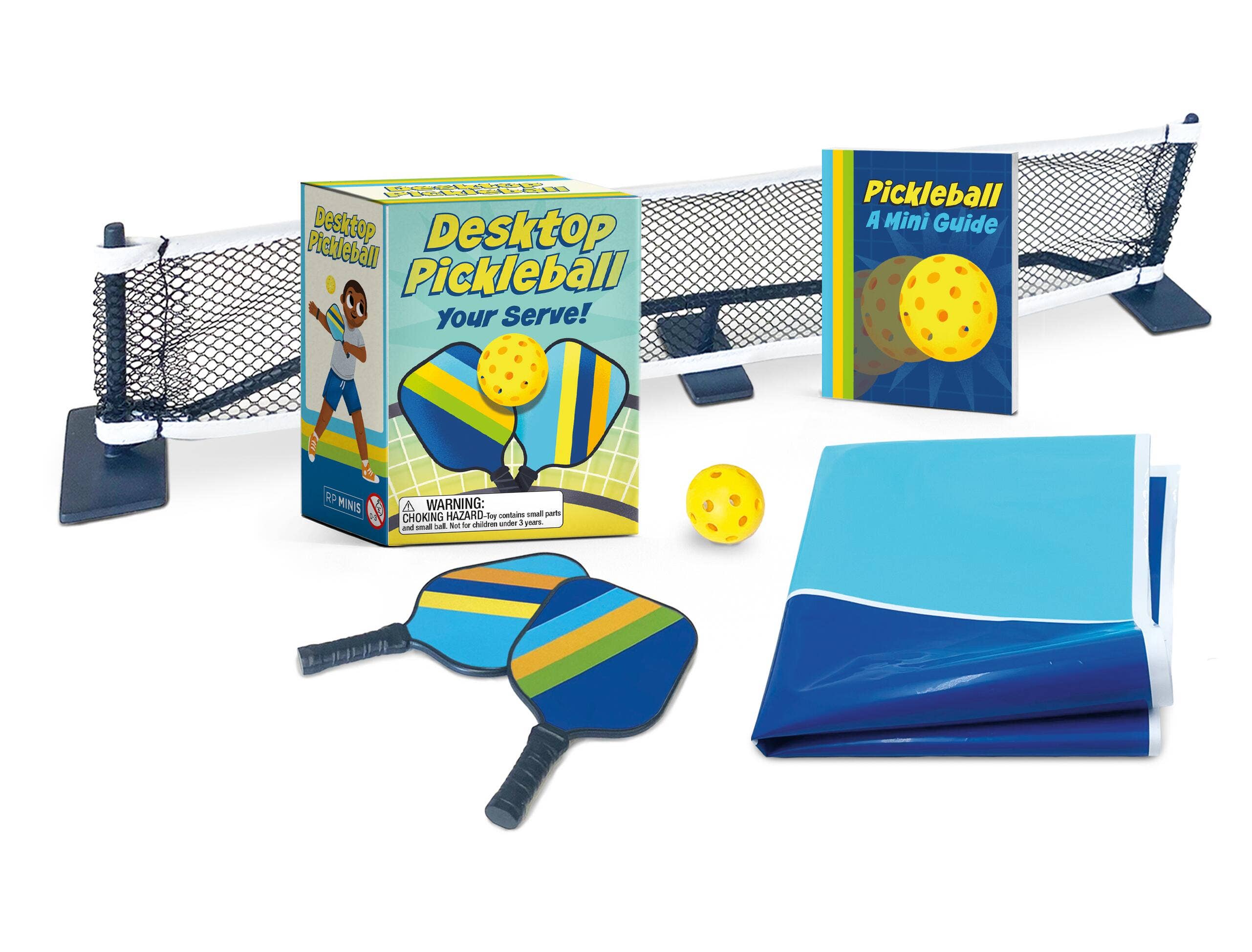 Desktop pickleball set with paddle, ball, and net on a white background