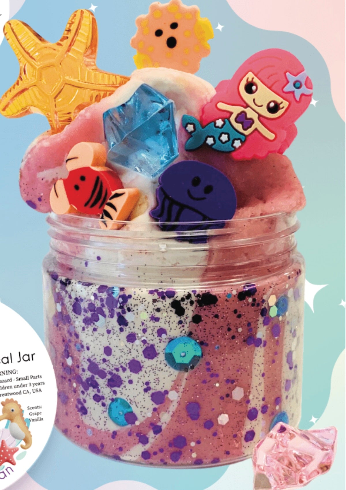 Decorative jar with mermaid-themed toys and a colorful glittery base on a light blue background.