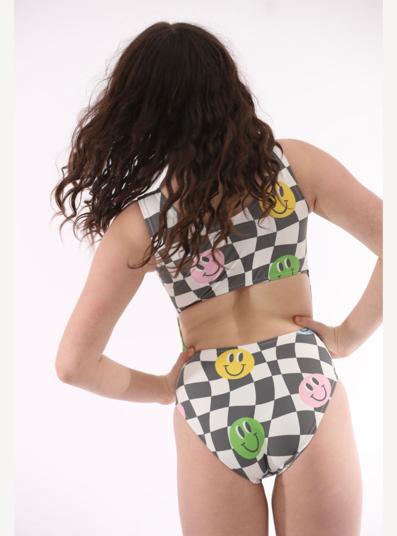 Open-back leotard with black and white checkers and smiley faces