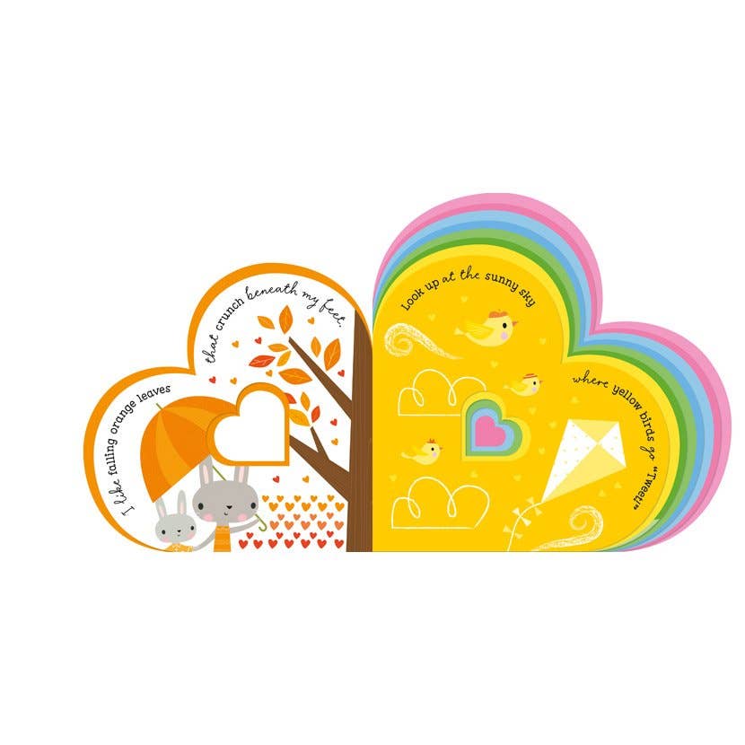 A children's book shaped like two overlapping hearts, shown on a plain white background. The left heart is orange with a tree, rabbits, and text, while the right heart is yellow with birds, clouds, and a heart-shaped rainbow.